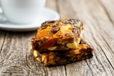 Lezzetli vejetaryen granola pasta dilimi ahşap masa kahve ile.