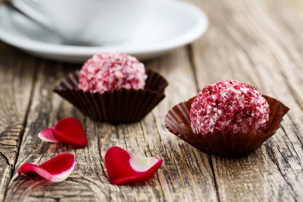 Delicious vegetarian truffle candies on wodden table.