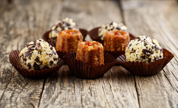 Delicious vegetarian candies anthill on wooden table for snack.