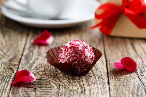 Delicious vegetarian truffle candies on wodden table.