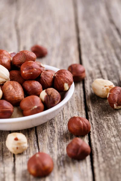 Hazelnuts on a white plate. — Stock Photo, Image