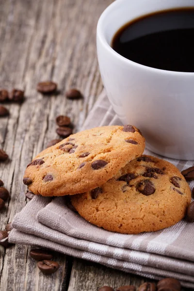 Tasty cookies and coffee cup on a wooden table. — Stock Photo, Image
