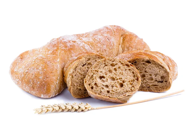 Tasty bread with slices on a white background. — Stock Photo, Image