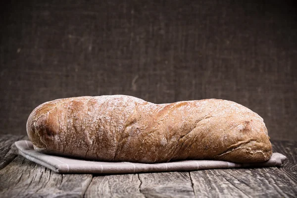 Pane saporito su sfondo di legno . — Foto Stock