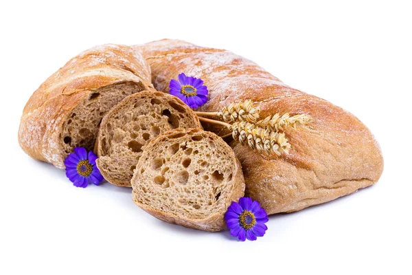 Tasty bread with wheat on a white background. — Stock Photo, Image