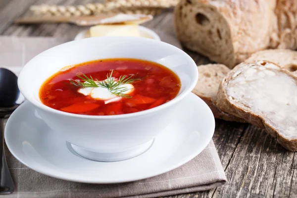 Tasty soup with bread on a wooden background. — Stock Photo, Image