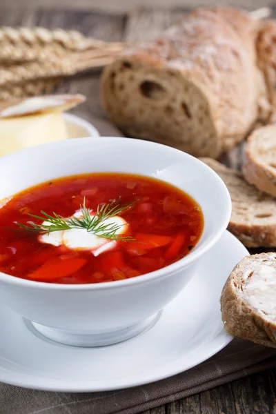 Tasty soup with bread on a wooden background. — Stock Photo, Image