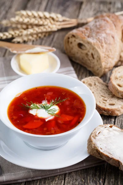 Lekkere soep met brood op een houten achtergrond. — Stockfoto