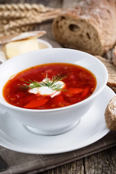 Tasty soup with bread on a wooden background. — Stock Photo, Image