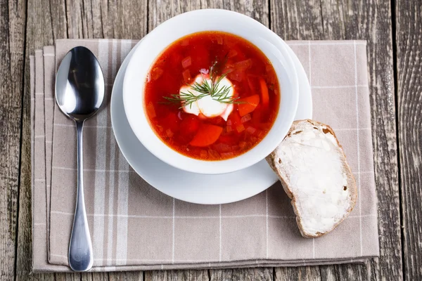 Tasty soup with bread on a wooden background. — Stock Photo, Image