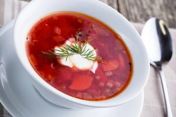 Tasty soup with bread on a wooden background. — Stock Photo, Image