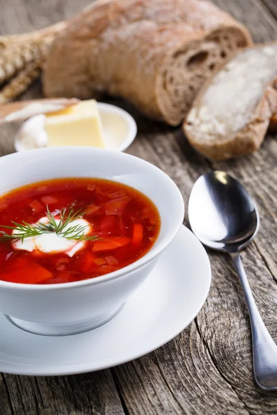 Tasty soup with bread on a wooden background. — Stock Photo, Image