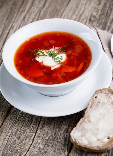 Tasty soup with bread on a wooden background. — Stock Photo, Image