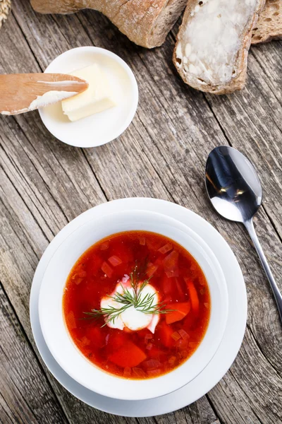 Tasty soup with bread on a wooden background. — Stock Photo, Image