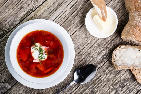 Tasty soup with bread on a wooden background. — Stock Photo, Image