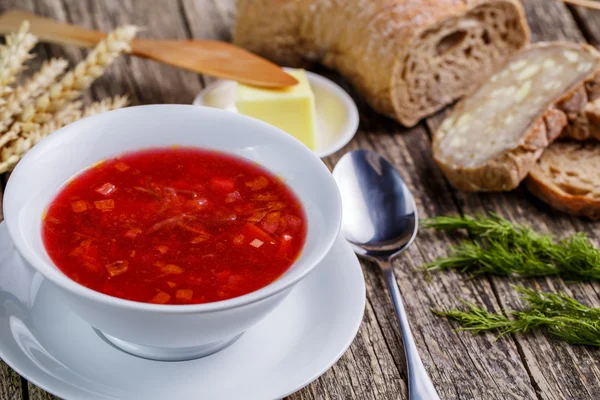 Tasty soup with bread on a wooden background. — Stock Photo, Image