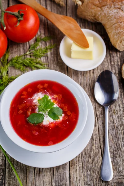 Tasty soup with bread on a wooden background. — Stock Photo, Image