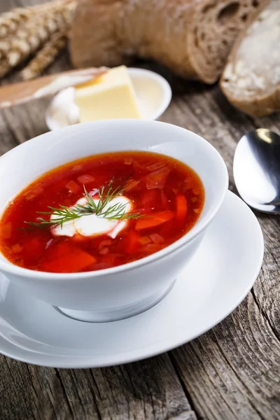 Tasty soup with bread on a wooden background. — Stock Photo, Image