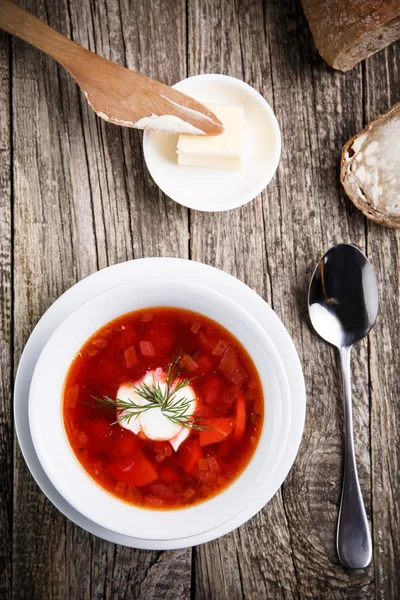 Tasty soup with bread on a wooden background. — Stock Photo, Image