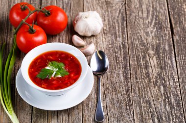 Borsch with bread on a wooden background. clipart