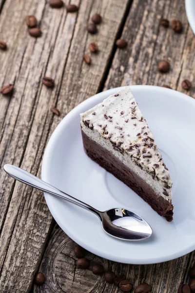 Chocolate dessert with coffee cup and coffee beans on wooden bac — Stock Photo, Image