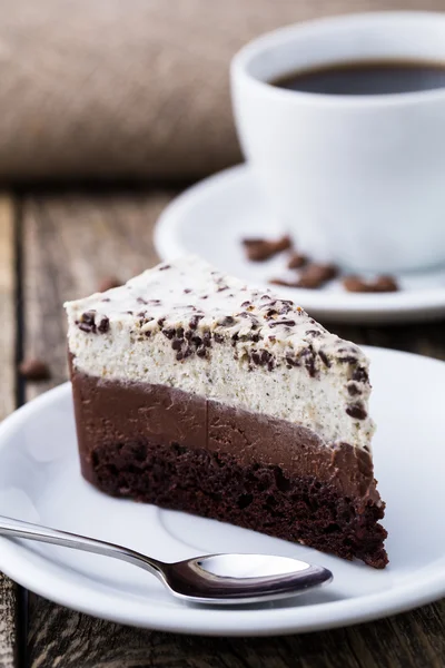 Schokoladendessert mit Kaffeetasse und Kaffeebohnen auf Holzbacken — Stockfoto