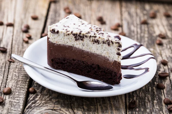 Chocolate dessert with coffee cup and coffee beans on wooden bac — Stock Photo, Image