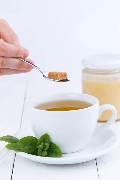 Mint tea with honey on wooden table. — Stock Photo, Image