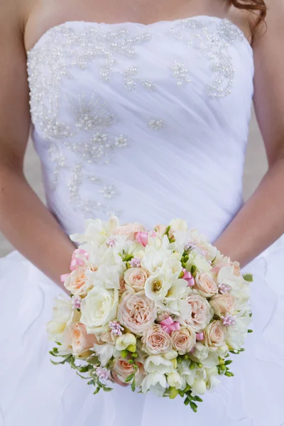 Brides wedding bouquet and wedding dress. — Stock Photo, Image