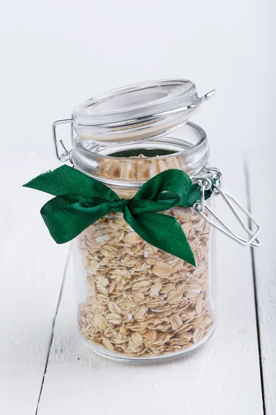 The oat flakes in glass jar and green ribbon.