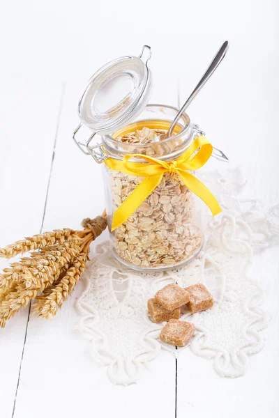 Los copos de avena en frasco de vidrio y trigo . —  Fotos de Stock