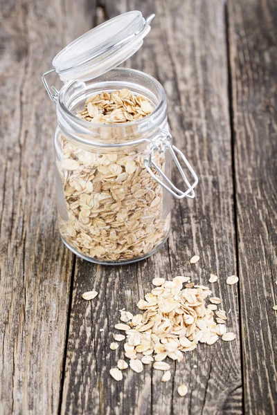 Copos de avena derramados del frasco . — Foto de Stock