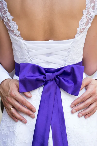 Groom is tenderly holding brides back. — Stock Photo, Image