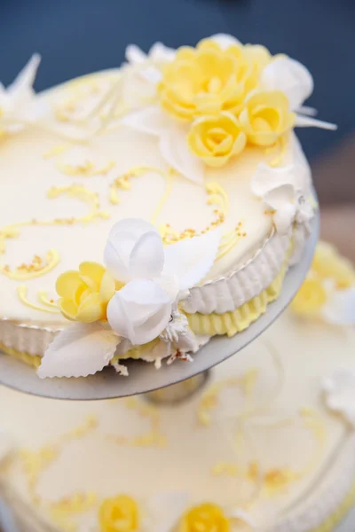 Tasty wedding cake with flowers.