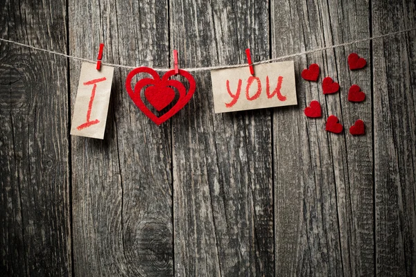 Handwritten words I love you and hearts on wooden background. — Stock Photo, Image