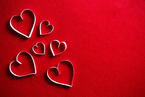 Бумажные сердца на красном фоне для подарка на день Святого Валентина . — стоковое фото