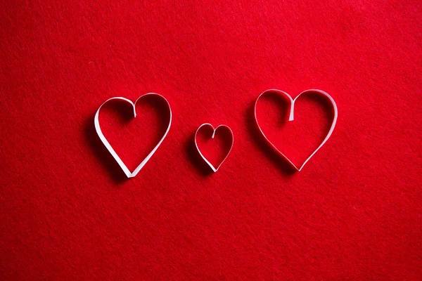 Paper hearts on red background for gift on valentines day. Stock Image