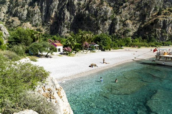 BUTTERFLY VALLEY BEACH, TURKEY - JUNE 01: Tourrists visit famous — стоковое фото