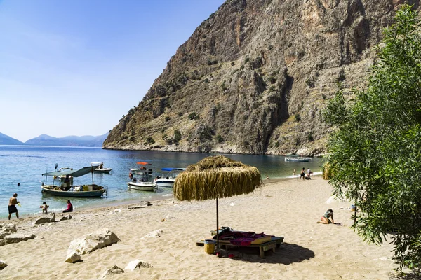 BUTTERFLY VALLEY BEACH, TURKEY - JUNE 01: Tourrists visit famous — стоковое фото