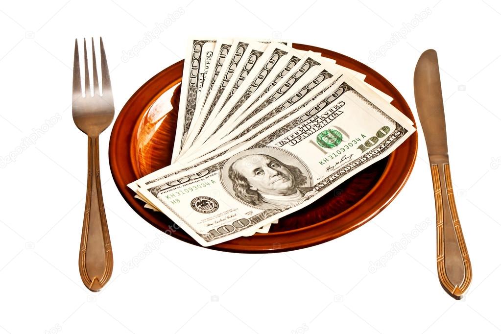 Money on the plate with fork and knife, isolated on white backgr