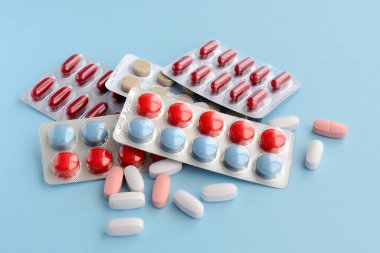 Mavi arka planda ilaç hapları. 