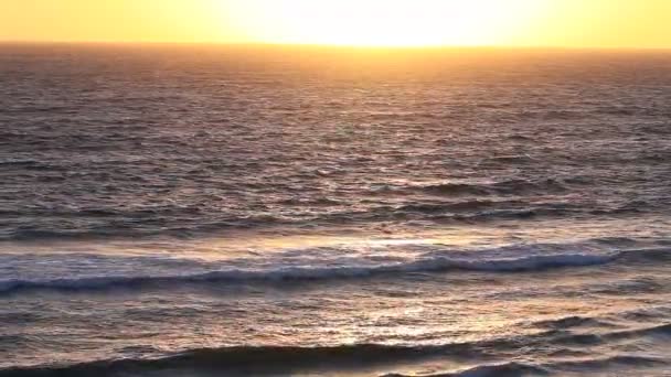 Colorful ocean water surface with surf during sunrise — Stock Video