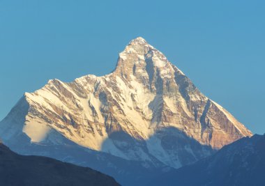 günbatımı konik kar kaplı tepe üzerinde