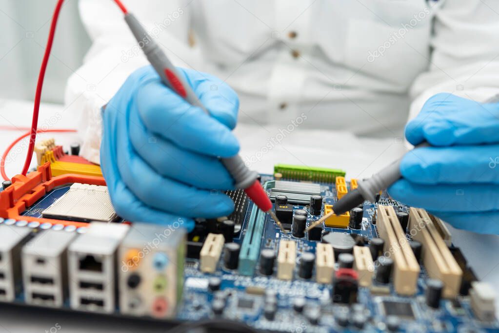 Technician repairing inside of hard disk by soldering iron. Integrated Circuit. the concept of data, hardware, and technology.