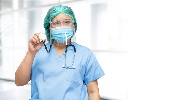 Asian doctor wearing face shield and PPE suit new normal to check patient protect safety infection Covid-19 Coronavirus outbreak at quarantine nursing hospital ward.