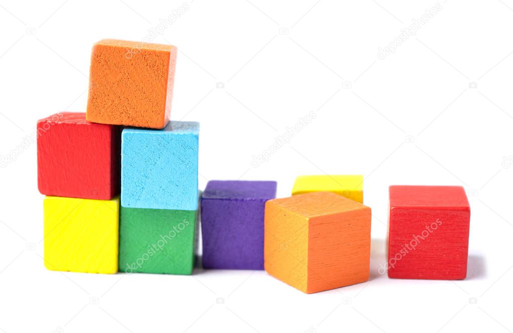 Wooden colorful building cube toy block on white background.