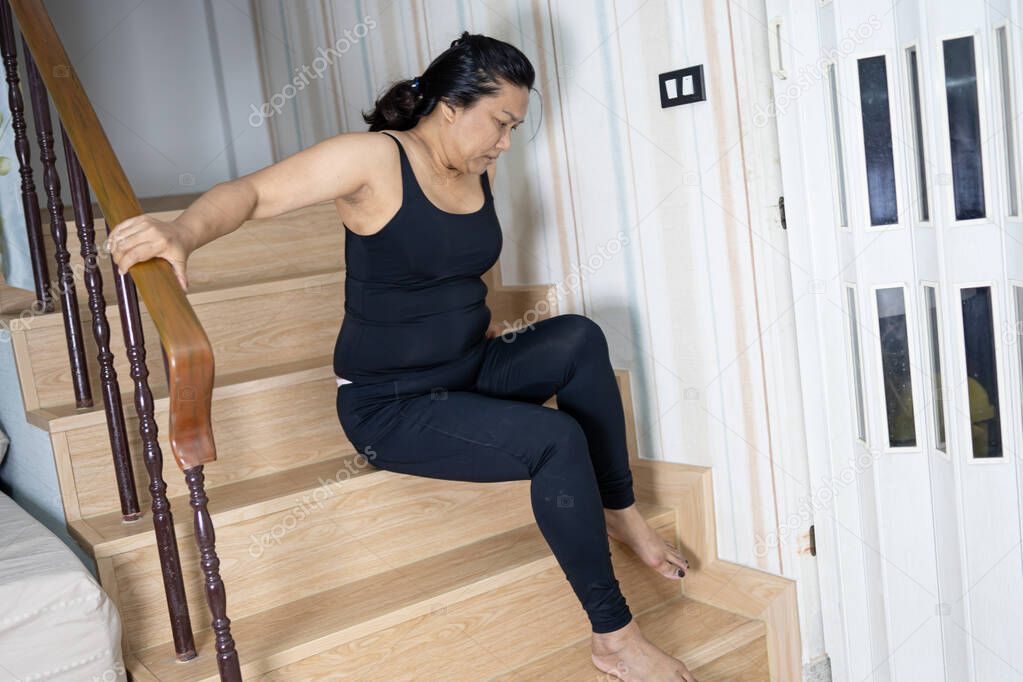 Asian middle-aged lady woman patient fall down the stairs because slippery surfaces