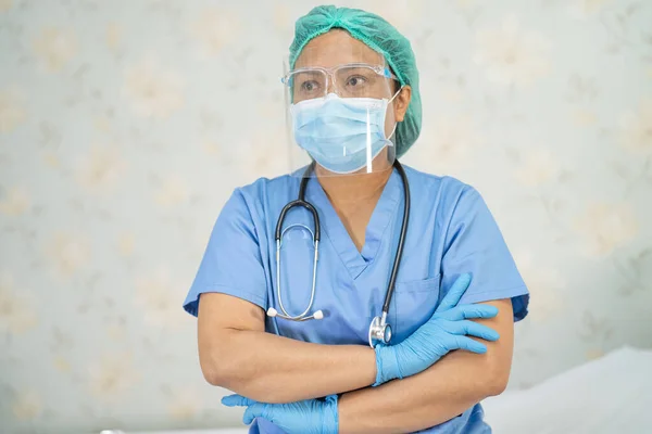 Asian doctor wearing face shield and PPE suit new normal to check patient protect safety infection Covid-19 Coronavirus outbreak at quarantine nursing hospital ward.