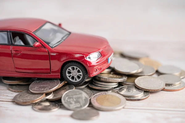 Car on coins background; Car loan, Finance, saving money, insurance and leasing time concepts.