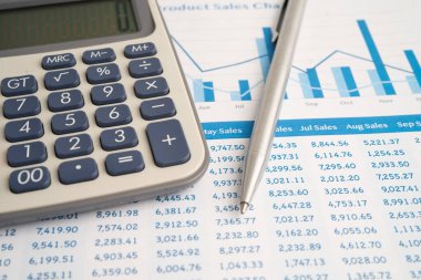 Pencil and calculator on chart or graph paper. Financial, account, statistics and business data.